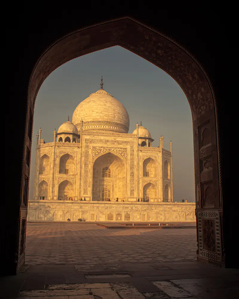 The Taj Mahal in Agra framed by a sandstone archway