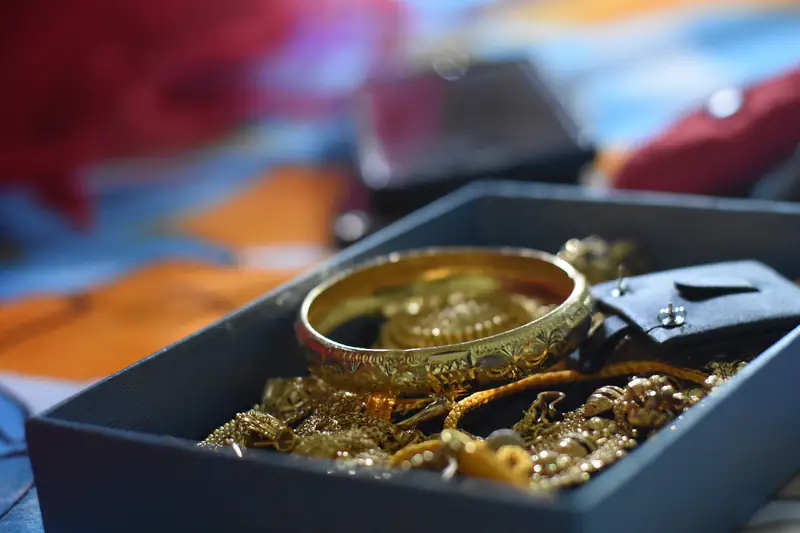 Gold bangle and jewellery in a presentation box
