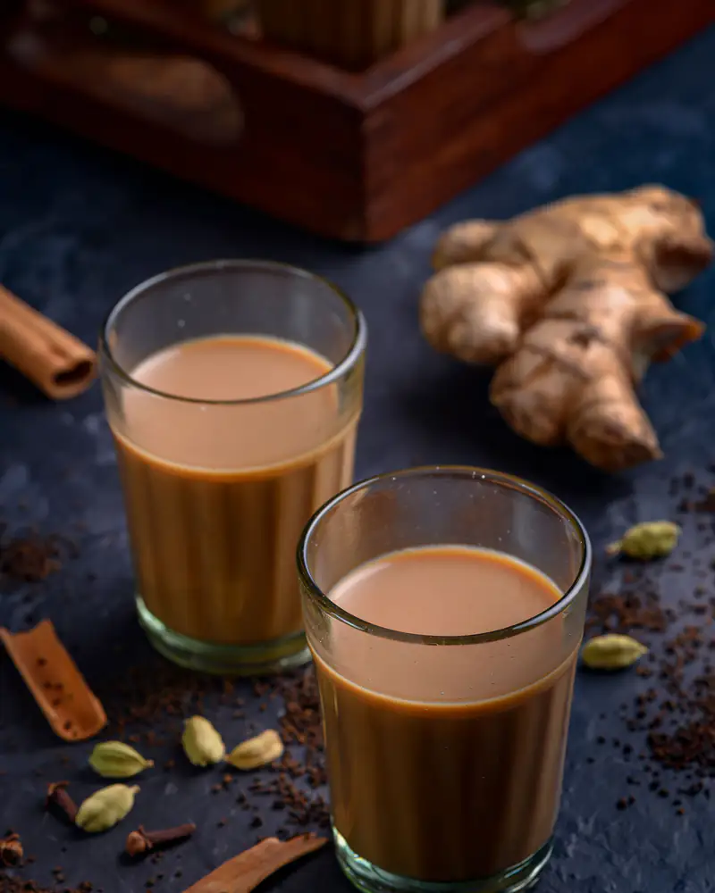 Two glasses of masala chai with ginger, cinnamon and cardamom